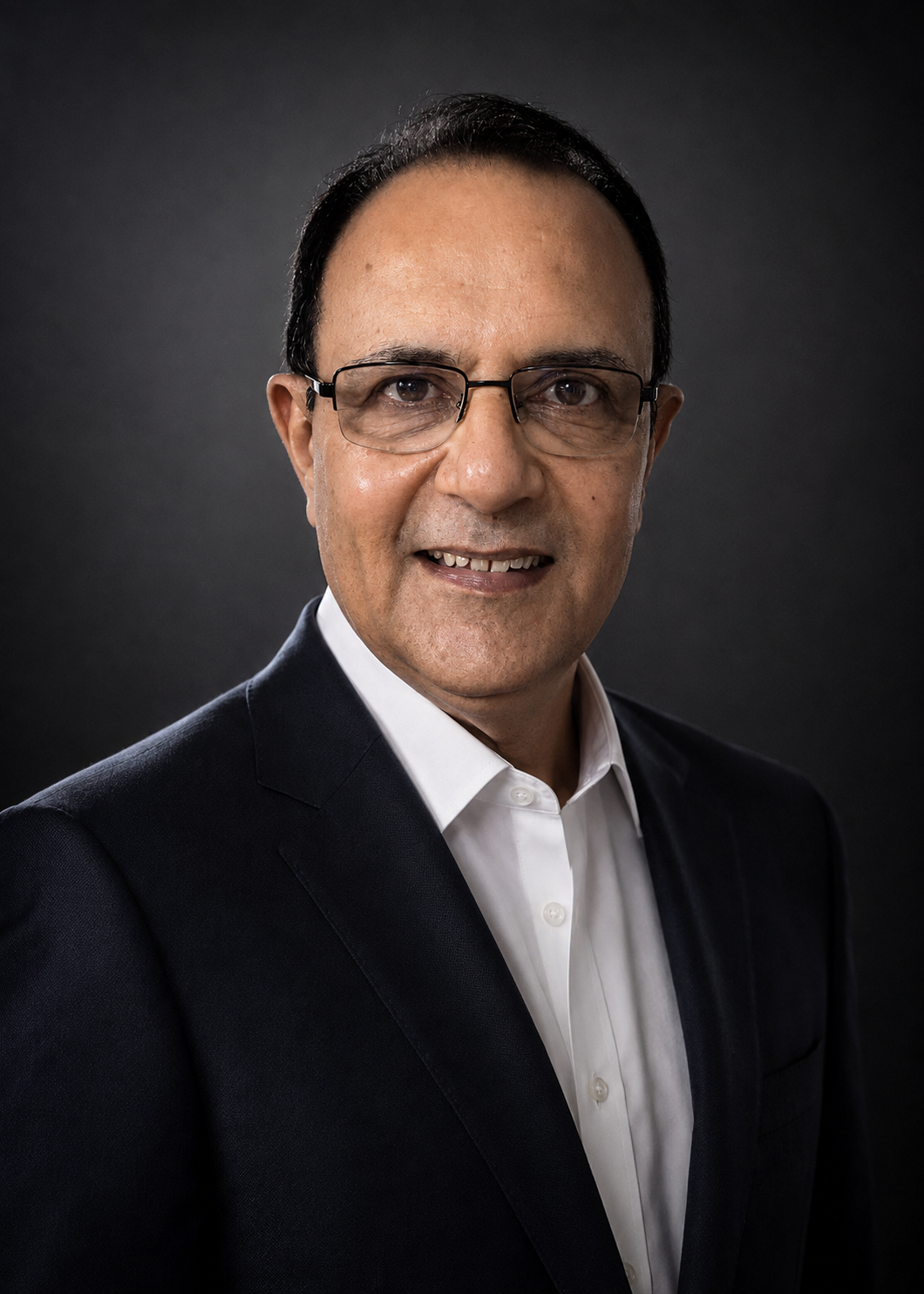 Headshot of Anupam Singh, Business Head Ford and Lincoln at Saud Bahwan Group, in a dark suit and white shirt against a dark studio background