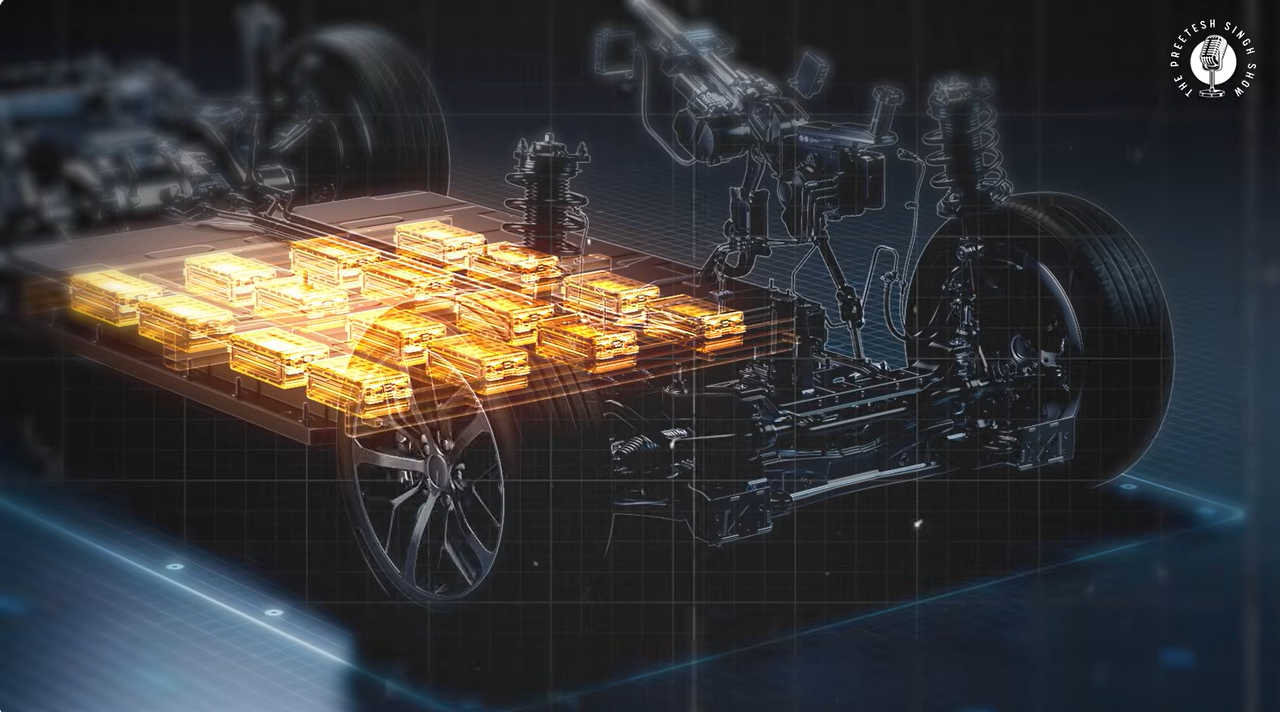 Transparent view of an electric vehicle chassis with glowing orange battery pack modules mounted along the floor, with the drivetrain and suspension shown in outline