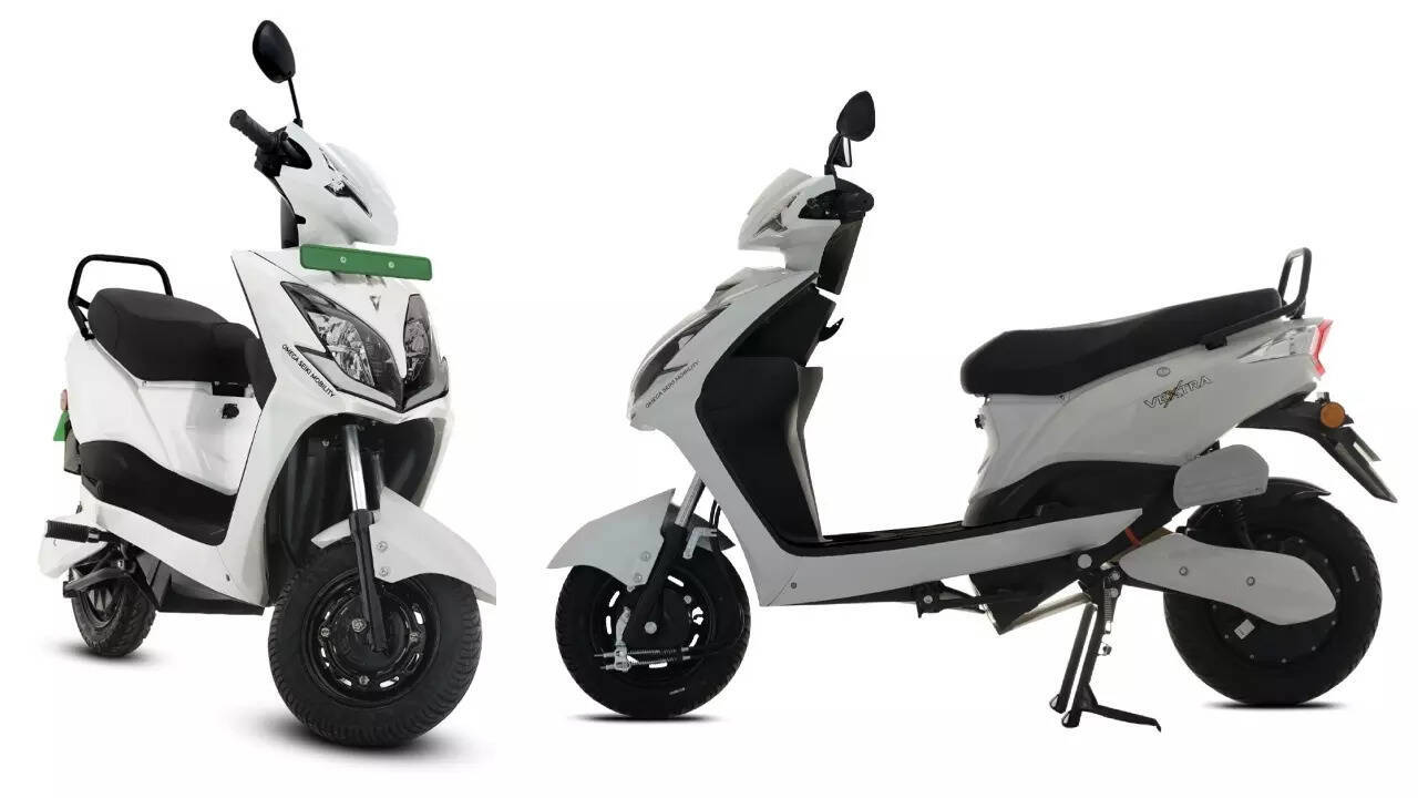 Two Omega Seiki Vextra electric scooters, a white model shown from the front three-quarter view and a white model in side profile with its centre stand down